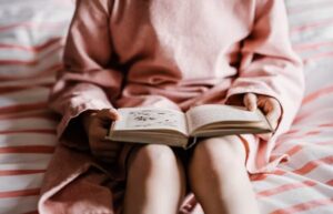 Girl reading Unsplalsh